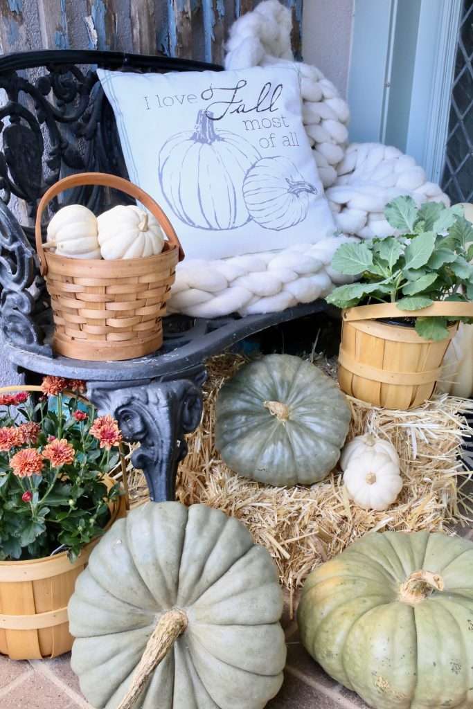 bench filled with pumpkins, mums and fall decor front porch decorated for fall