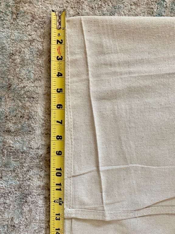 using the measurements fold the top of the drop cloth curtain accordingly